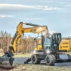 Excavadora de ruedas SANY SY175W con brazo partido, operando en terreno abierto.