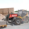 Manipulador SANY STH625E descargando pallet de bloques en obra exterior.